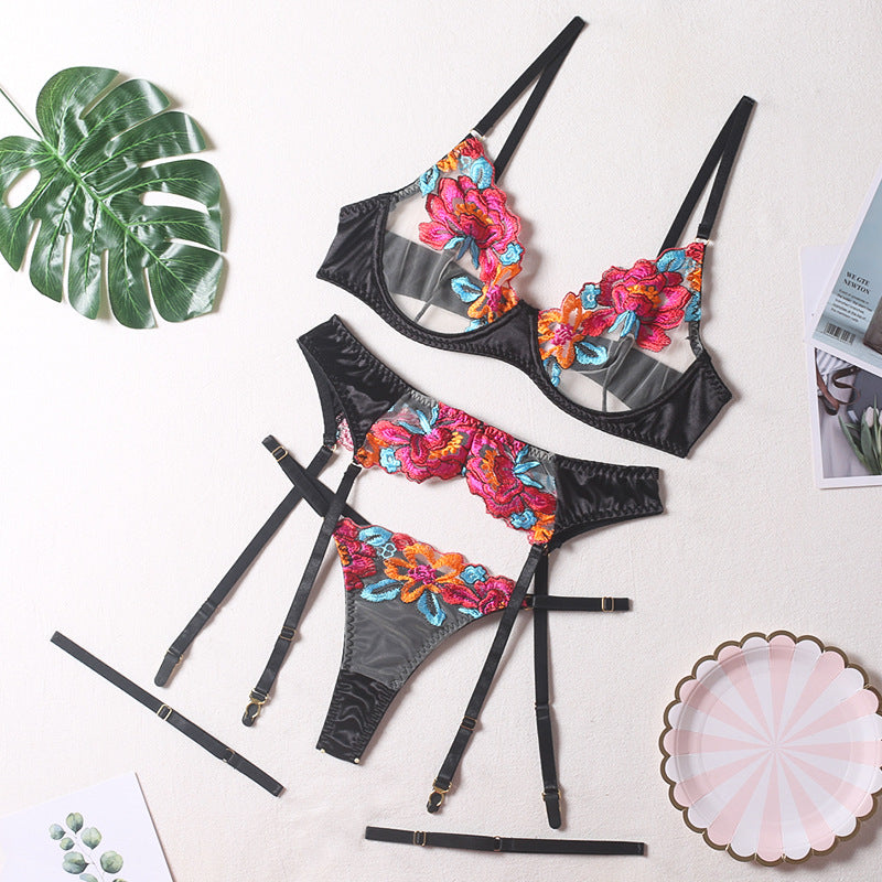 Seductive color-block embroidered floral bra set with underwire, garter belt, thigh garters, and crotchless panties on display.
