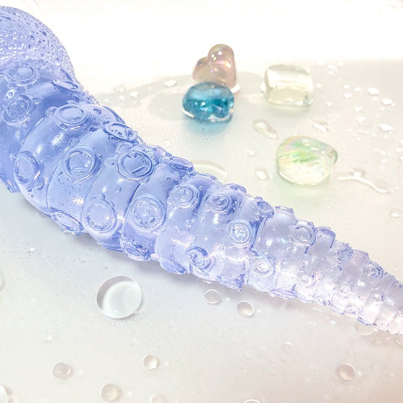 Octopus tentacle anal plug with realistic PVC shaft and beads in a waterproof silicone design.